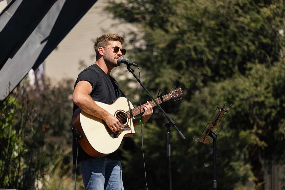 Harry singing outdoors in sunglasses
